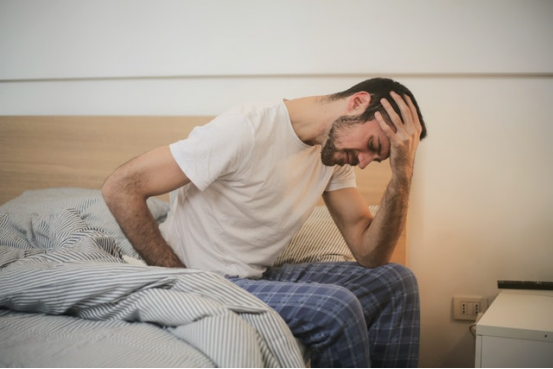 Mr Safology, man in pain abdoman cramp pain on bed, headache